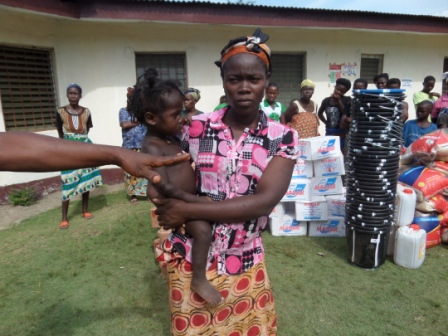Felecial King (holding baby) lost all family members to ebola in Worhn
