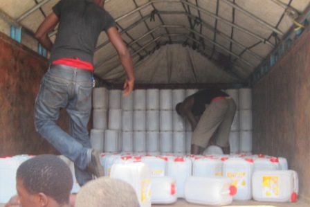 Loading one of the trucks with oil for Margibi