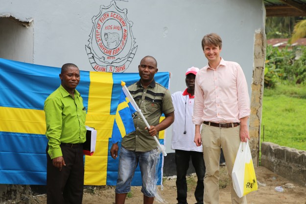 Handover of flag to the principal Emmanuel M. Nyantee